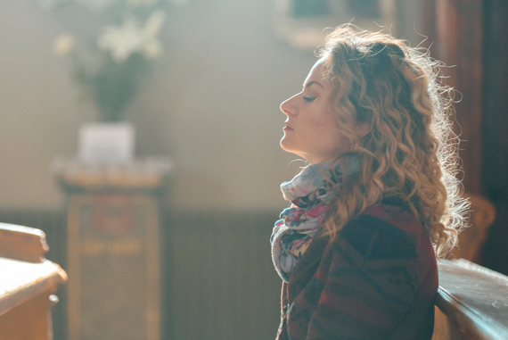 Woman meditating in soft light.