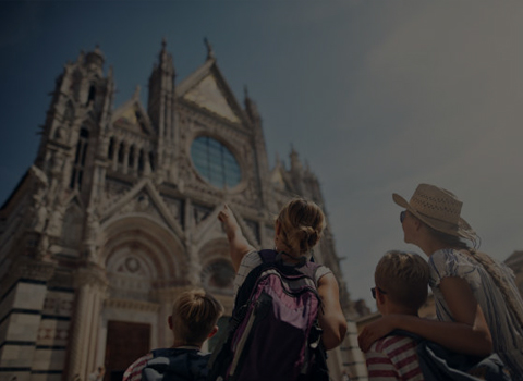 Family admiring a cathedral's architecture.