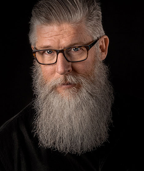 Older man with glasses and a long beard.