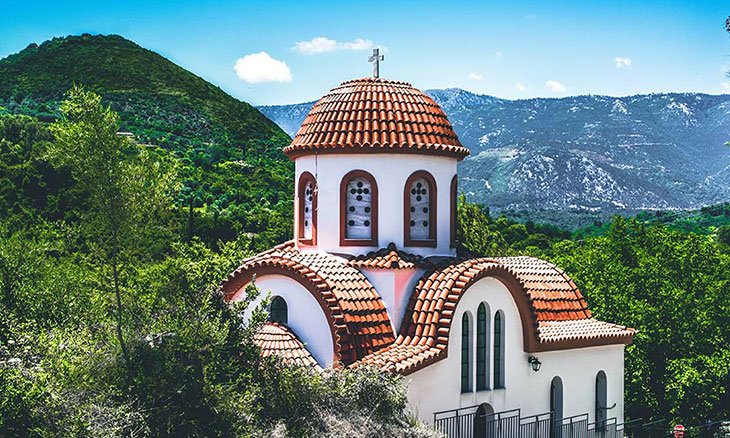 Mediterranean church surrounded by mountains.